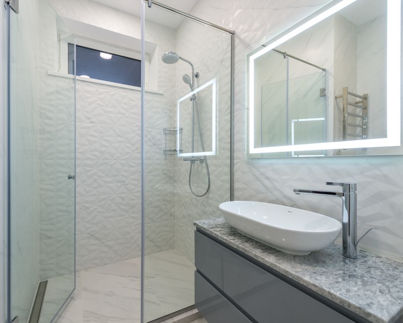 Modern walk-in shower with sleek glass doors and elegant tiling